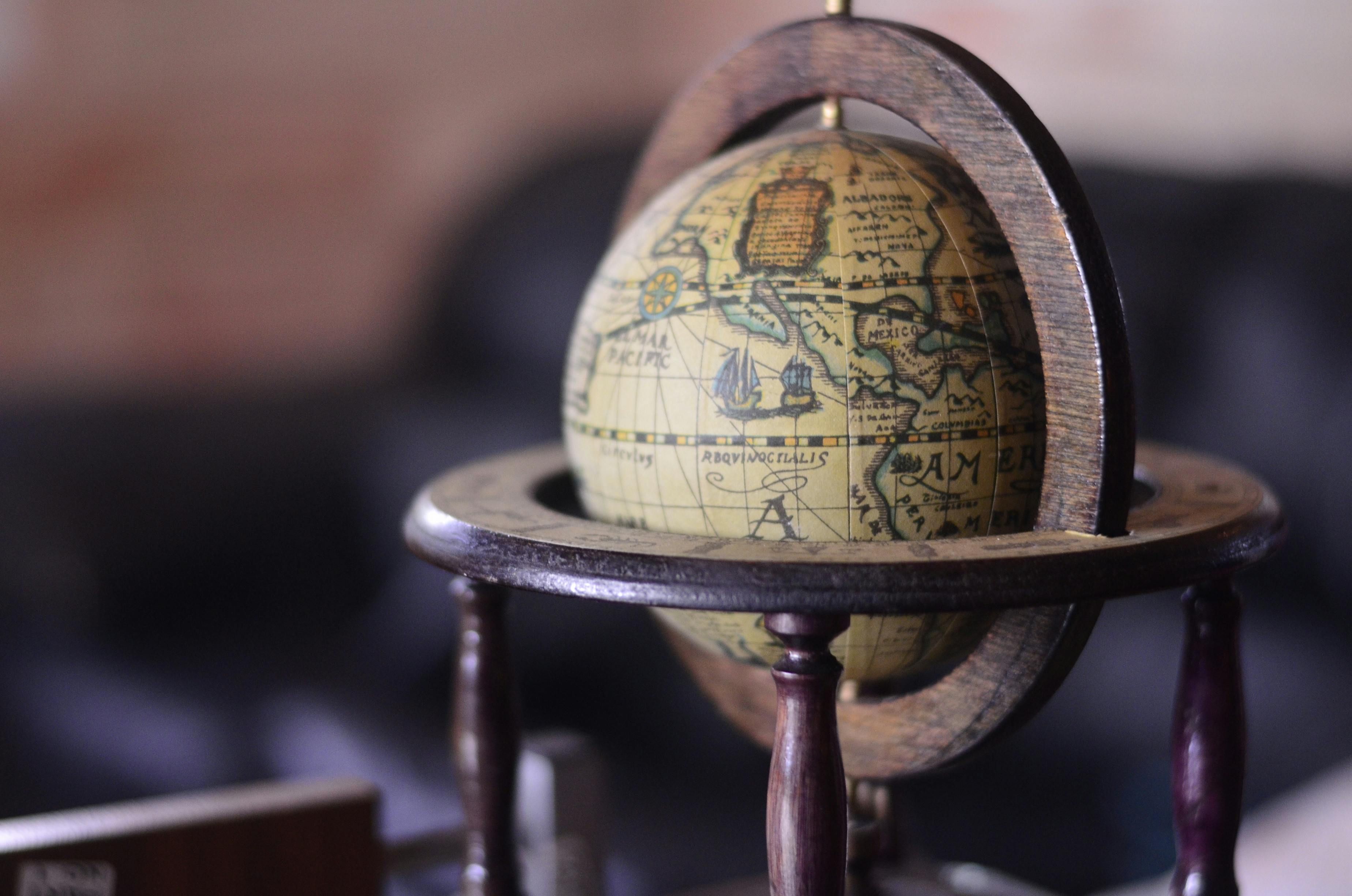A passport resting on a world map with highlighted routes, representing international movement and global financial strategy.